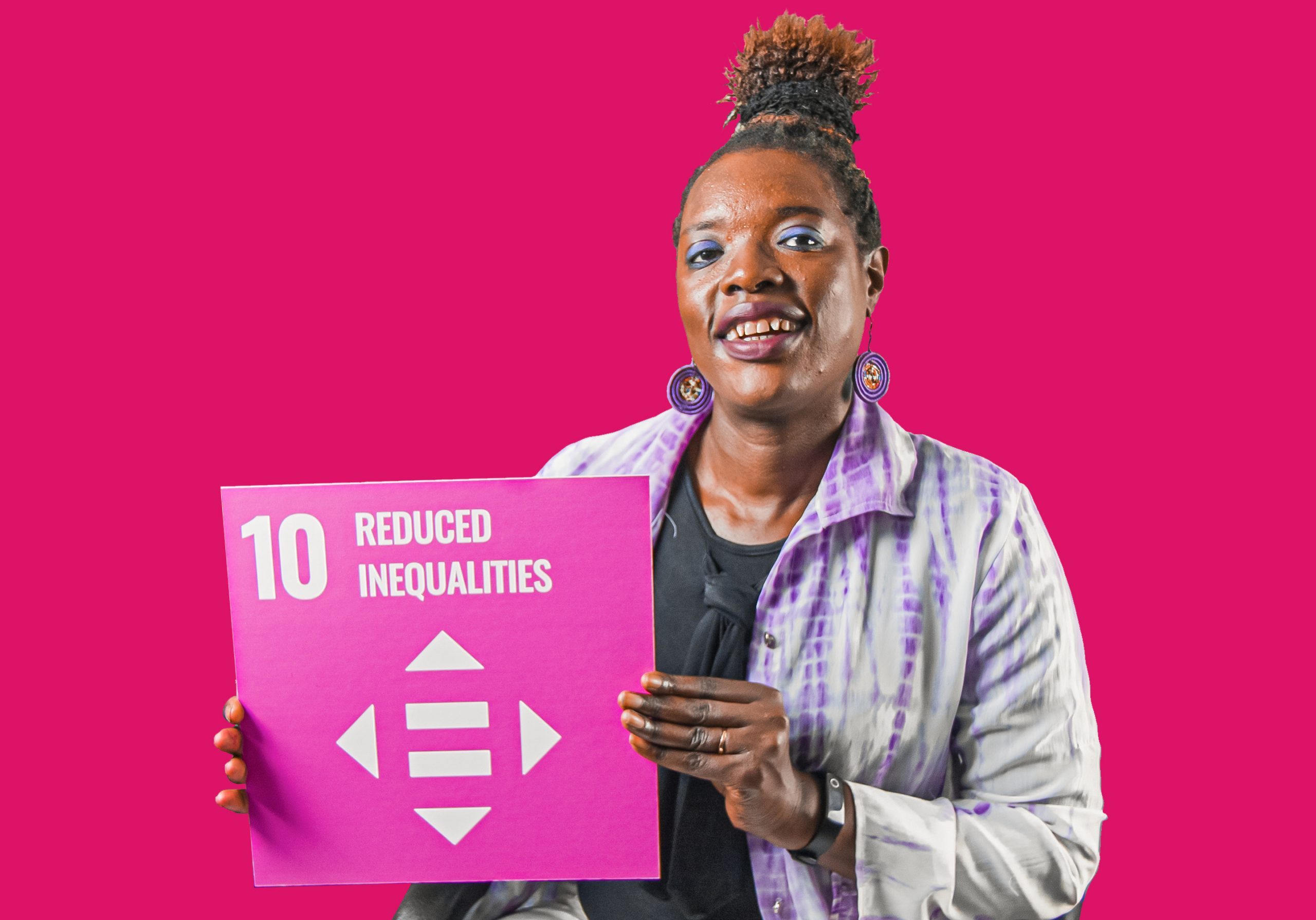 Woman holding up sign showing Global Sustainable Development Goal 10, reduced inequalities.