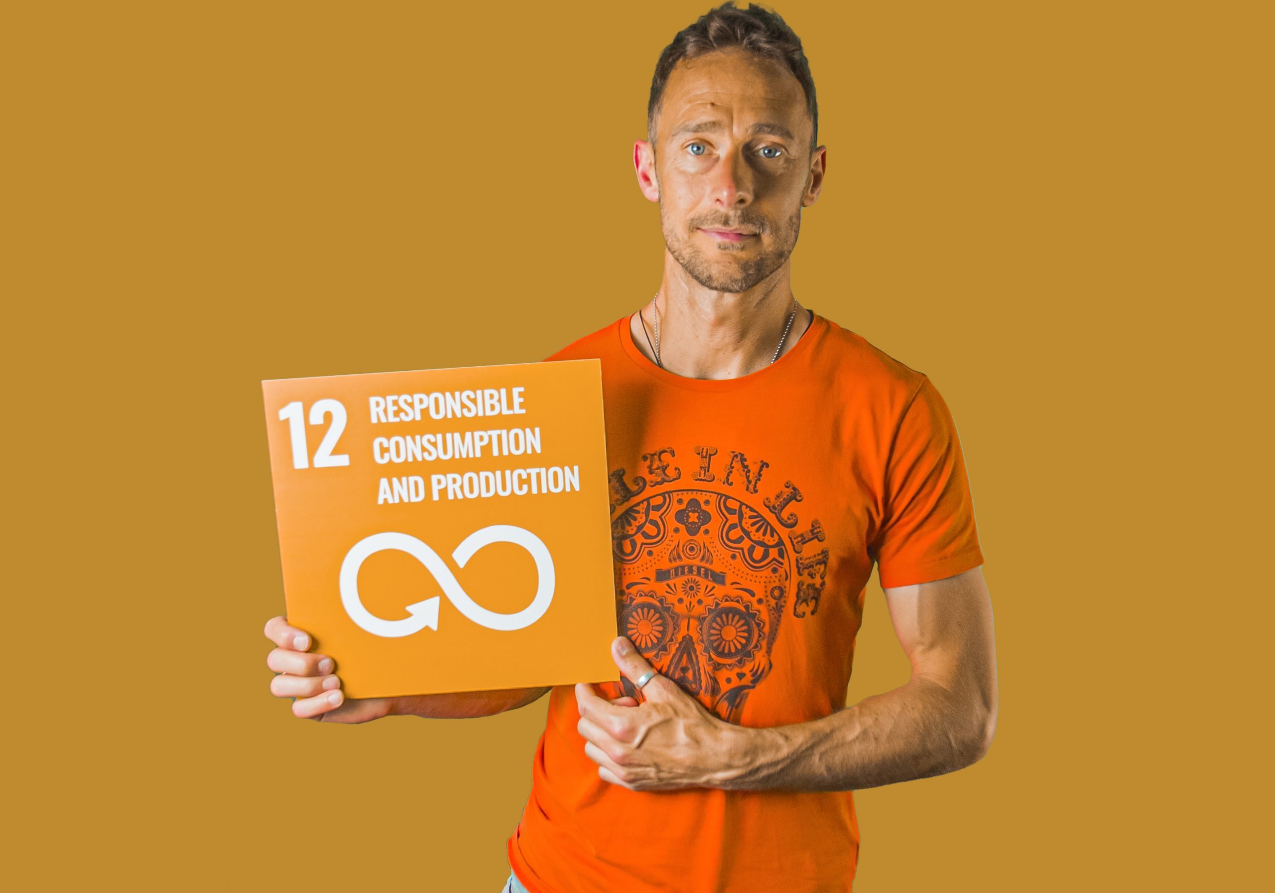 Man holding up sign showing Global Sustainable Development Goal 12, responsible consumption and production.